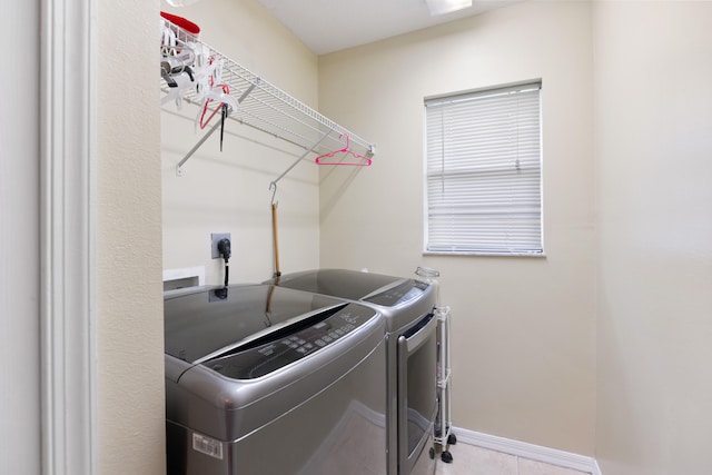 washroom with independent washer and dryer and light tile patterned floors