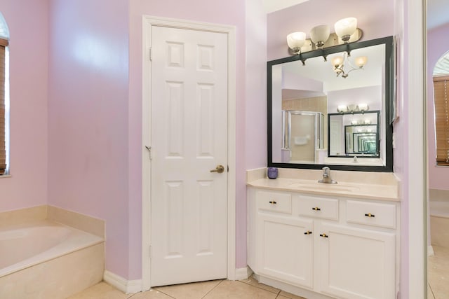 bathroom with tile patterned flooring, shower with separate bathtub, and vanity