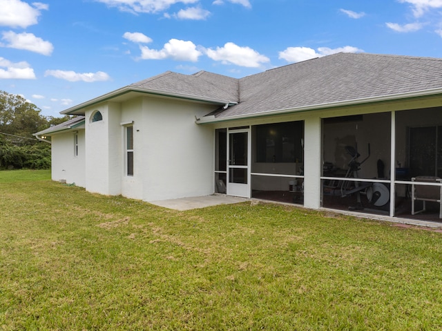 rear view of property with a yard and a sunroom