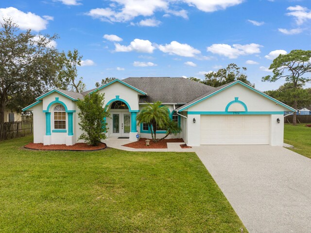 single story home featuring french doors, a front lawn, and a garage