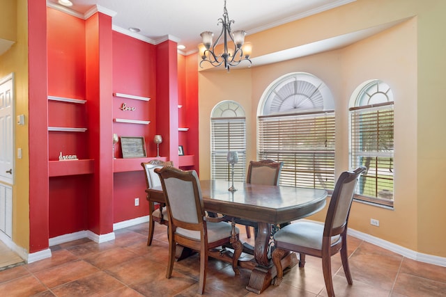 dining room with a chandelier, built in shelves, dark tile patterned floors, and crown molding