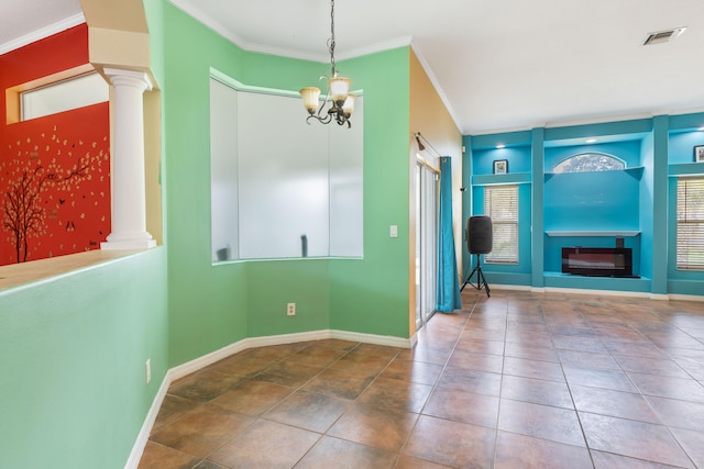 interior space with built in shelves, a chandelier, and ornamental molding