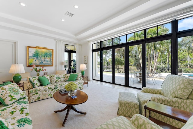 carpeted living room featuring expansive windows, french doors, and a wealth of natural light