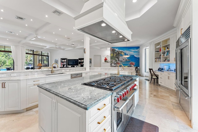 kitchen with kitchen peninsula, premium range hood, a spacious island, white cabinetry, and sink