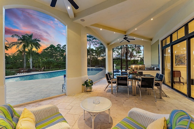 patio terrace at dusk with ceiling fan and an outdoor living space