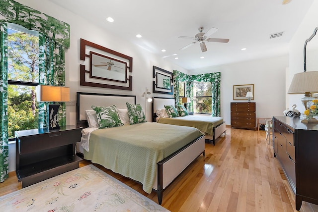 bedroom with multiple windows, ceiling fan, and light hardwood / wood-style flooring