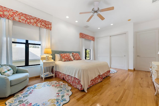 bedroom with a closet, ceiling fan, and light hardwood / wood-style floors