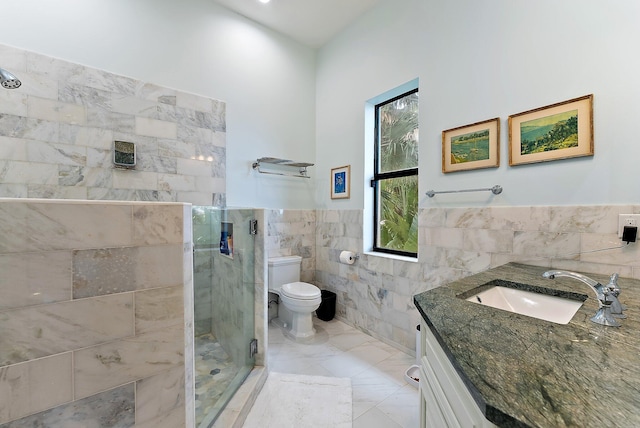 bathroom featuring tile walls, walk in shower, vanity, and toilet