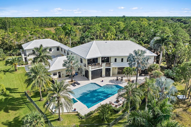 view of swimming pool featuring a patio area and a yard