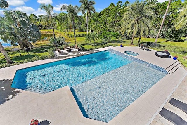 view of swimming pool with a yard, an in ground hot tub, and a patio area