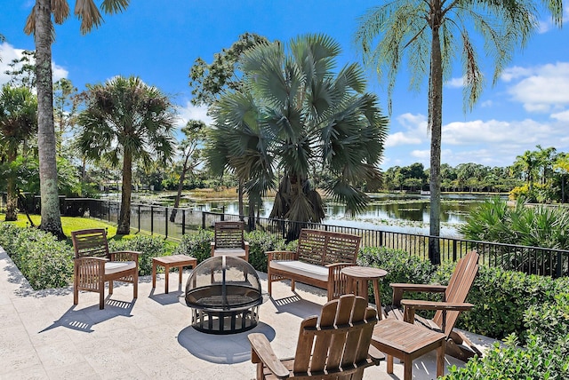 view of patio / terrace with an outdoor fire pit and a water view