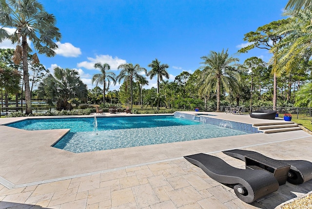 view of pool with pool water feature and a patio