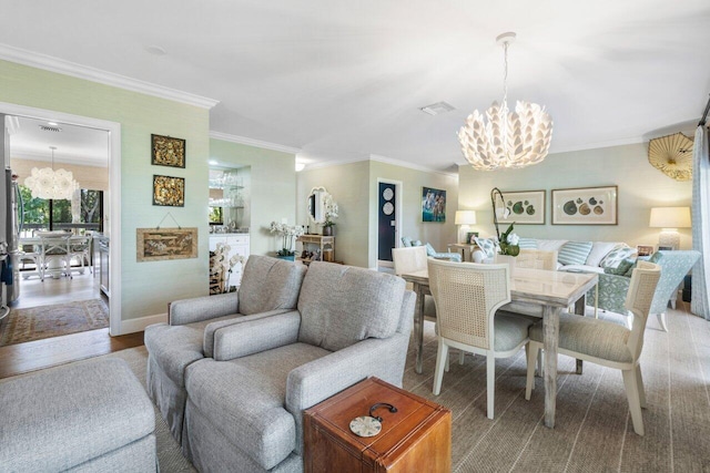 living room with ornamental molding, wood-type flooring, and a chandelier