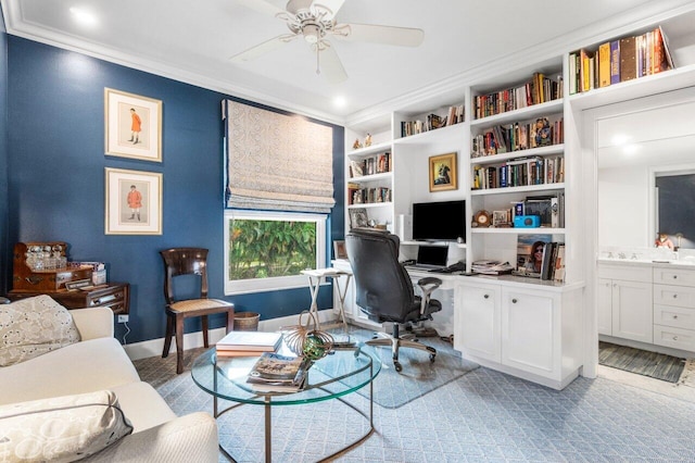 office featuring crown molding, built in shelves, and ceiling fan