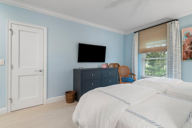 carpeted bedroom with ornamental molding and ceiling fan