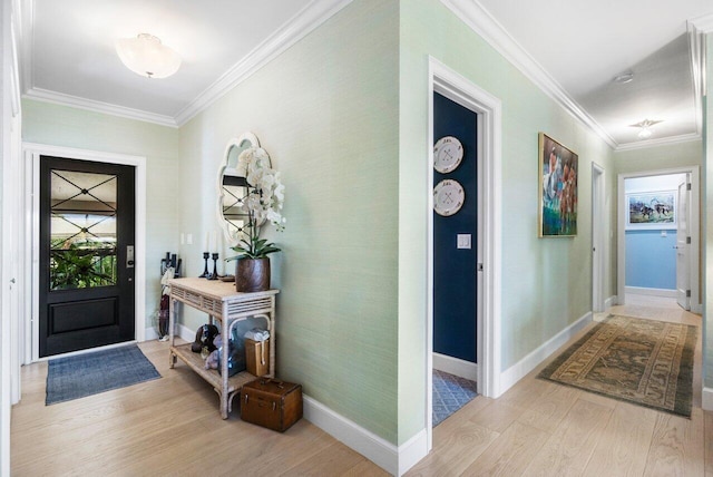 foyer featuring ornamental molding and light hardwood / wood-style flooring