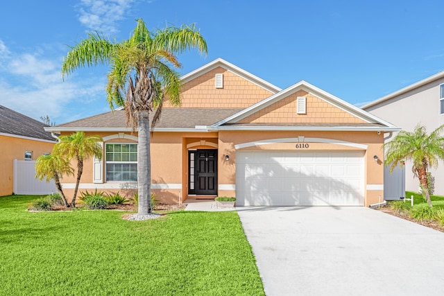 view of front of property with a garage and a front yard