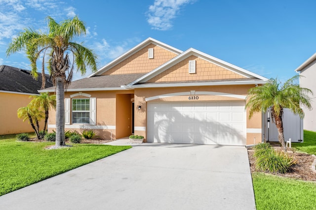 view of front of house featuring a front yard and a garage