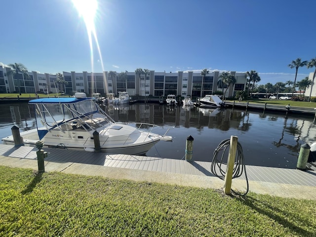 dock area featuring a water view and a yard