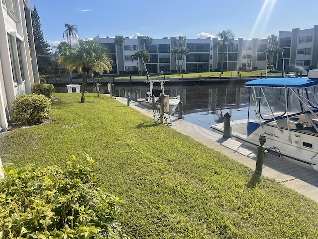 view of dock featuring a lawn