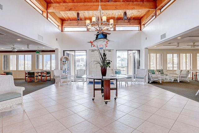 unfurnished dining area featuring ceiling fan with notable chandelier, a healthy amount of sunlight, wood ceiling, and light tile patterned floors