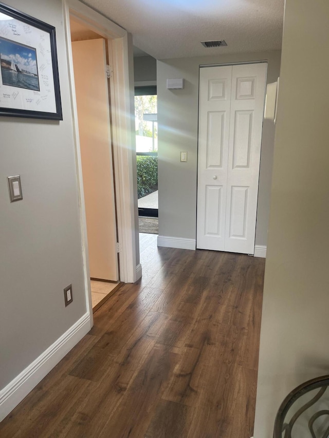 hall featuring dark wood-type flooring