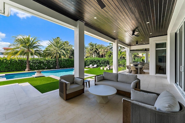 view of patio / terrace featuring outdoor lounge area, a fenced in pool, and ceiling fan