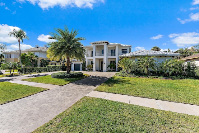 mediterranean / spanish house with a front yard and a balcony