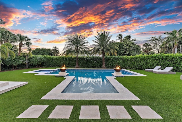 pool at dusk with a yard