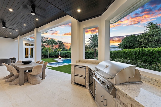 patio terrace at dusk featuring a fenced in pool, area for grilling, and ceiling fan