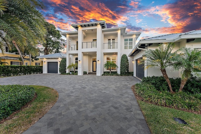 view of front of property with a balcony and a garage