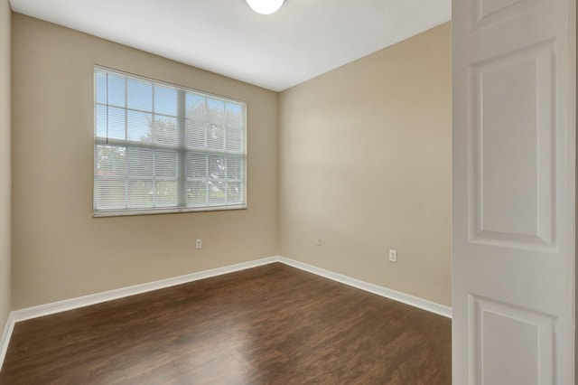 spare room featuring dark hardwood / wood-style flooring