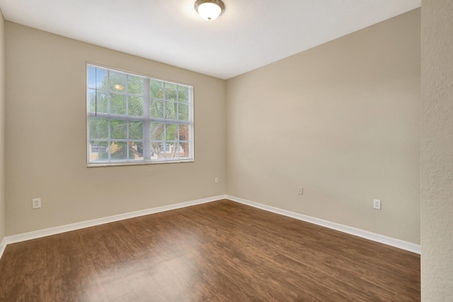 unfurnished room featuring dark hardwood / wood-style flooring