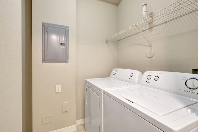 washroom with separate washer and dryer and electric panel