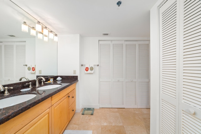 bathroom with tile patterned flooring and vanity