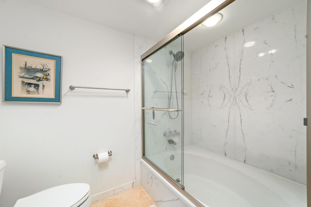 bathroom with tile patterned floors, enclosed tub / shower combo, and toilet