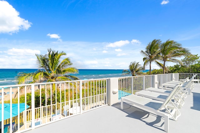 exterior space featuring a water view and a beach view