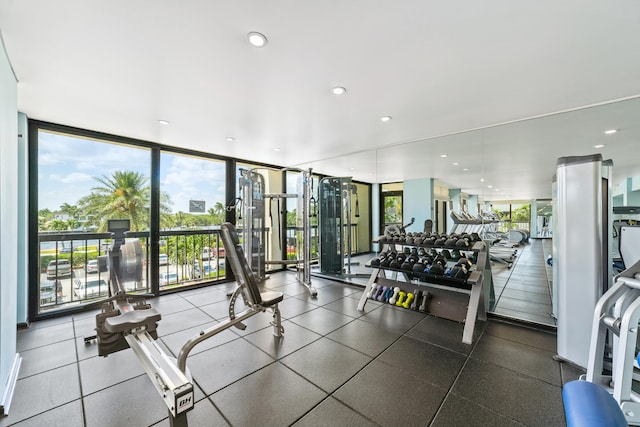 gym featuring a wall of windows and a healthy amount of sunlight