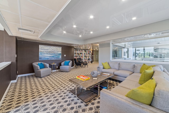 carpeted living room featuring a raised ceiling