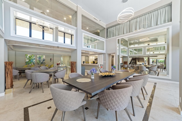 tiled dining space featuring a high ceiling