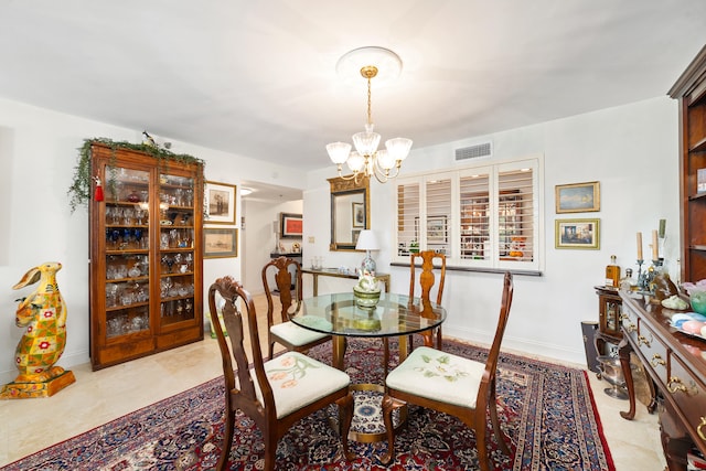 dining area featuring an inviting chandelier and light tile patterned flooring