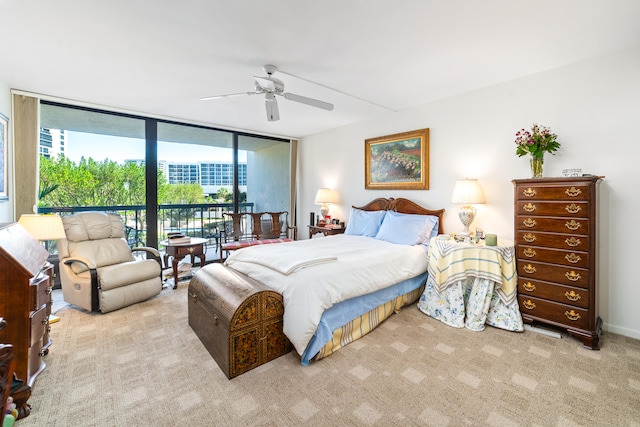 carpeted bedroom featuring expansive windows, access to outside, and ceiling fan