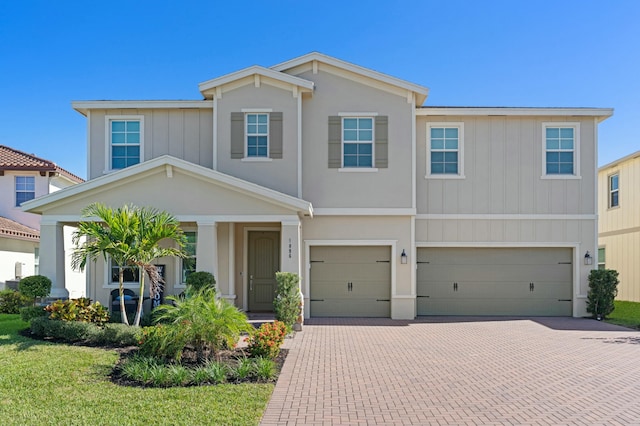 view of front of property with a garage and a front yard