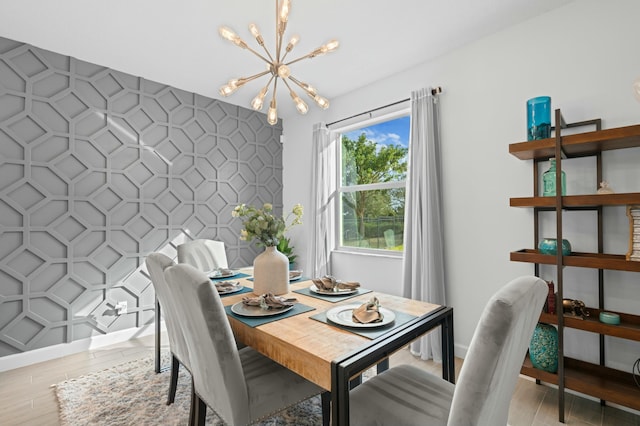 dining space featuring light hardwood / wood-style flooring and a notable chandelier