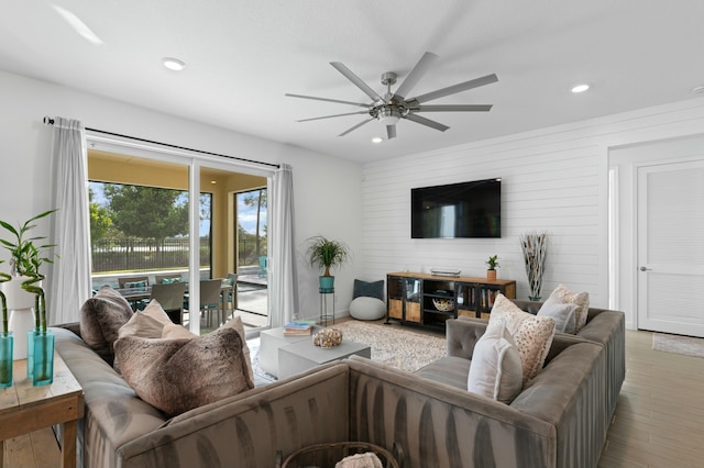 living room featuring ceiling fan and light hardwood / wood-style flooring