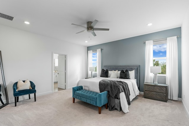 carpeted bedroom featuring ceiling fan and ensuite bathroom