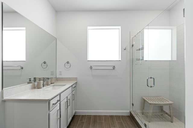 bathroom featuring vanity and a shower with door