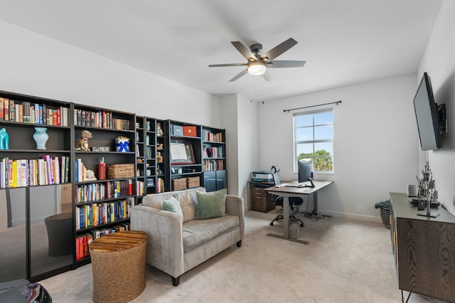 carpeted office space featuring ceiling fan