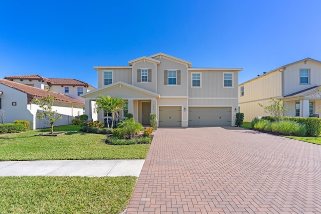 view of front of home with a front lawn and a garage