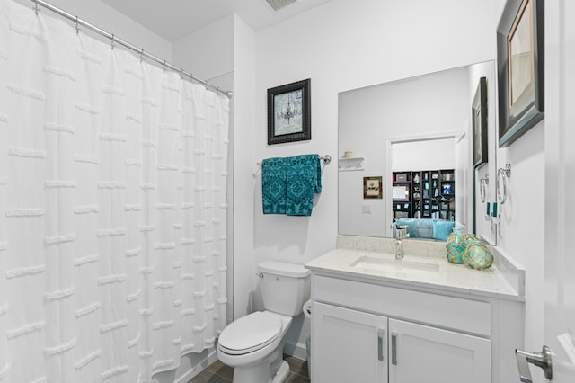 bathroom with toilet and vanity